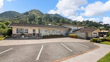 A building with a paved driveway and a parking area.