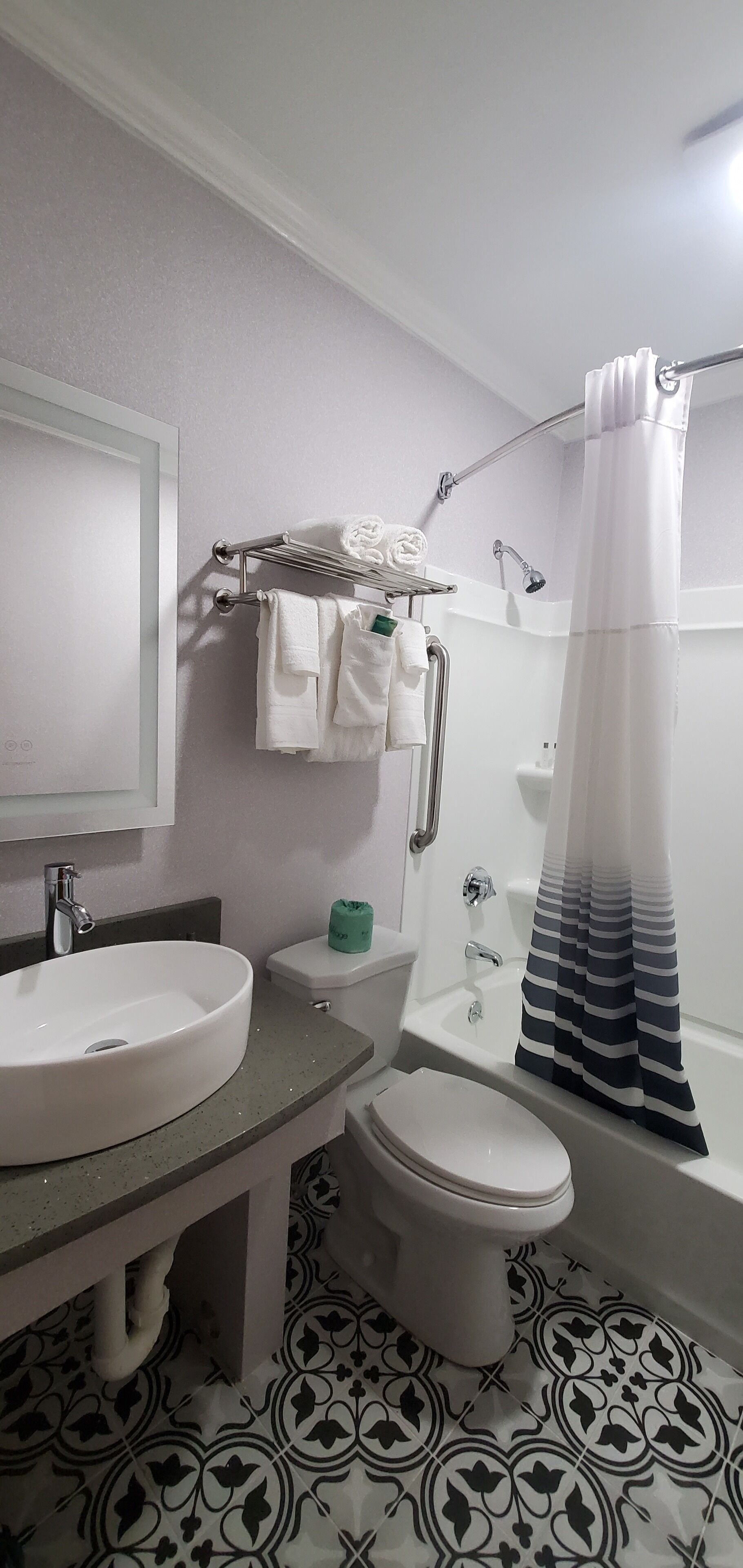 A bathroom with a sink, toilet, and shower.