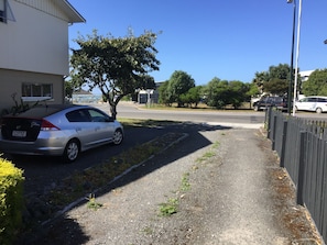 Stroll through a charming residential neighborhood with trees and a scenic view.