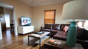 A living room with a television, sofa, coffee table, and a lamp. -  Wonderful 2/1 in Bouldin area.Walk to food trailers, Zilker and Barton Springs! (Austin)