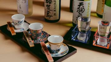 A tray with two cups and two shot glasses, each with a wooden handle.