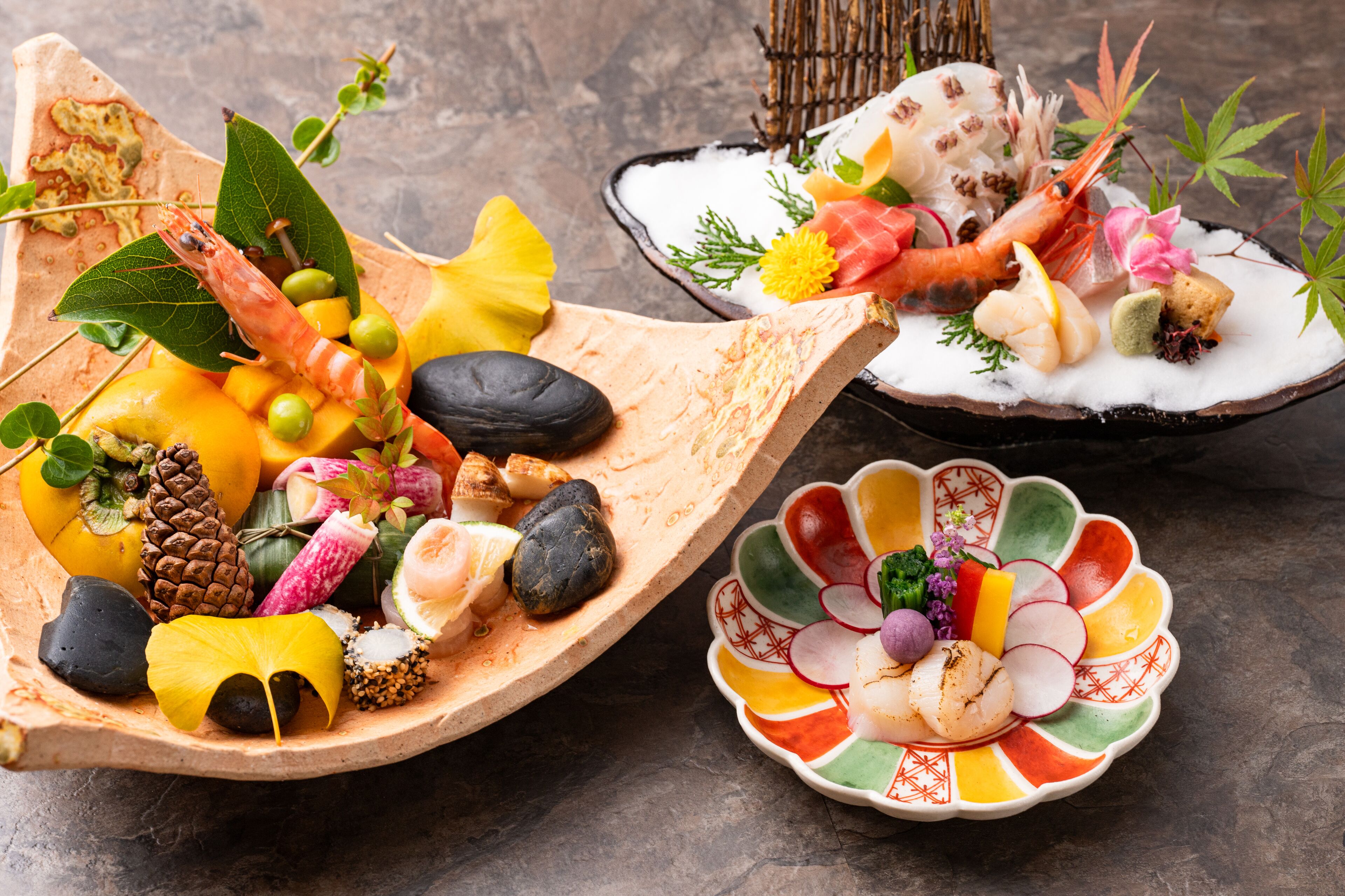 A variety of seafood and fruits arranged on wooden and ceramic dishes.