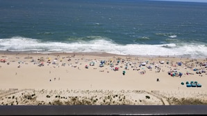 A beach with numerous umbrellas and people. - Direct Oceanfront Condo, Amazing Views of Ocean and Bay (Ocean City)