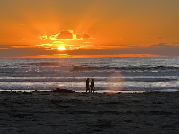 Warm ocean waves gently lap at the shoreline, inviting you to take a leisurely walk along the beach.