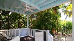 A covered outdoor area with a ceiling fan, white railing, and seating. - September dates w/last minute booking discount, w/Cabana Club Access Included! (Marathon)