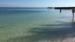 A clear view of a beach with calm waters and a pier in the distance. - September dates w/last minute booking discount, w/Cabana Club Access Included! (Marathon)