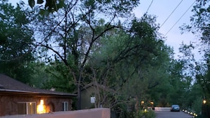 A gated entrance with a 'Welcome' sign, a paved driveway, and a car parked in the distance. - Casita (Prescott)