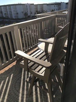 Relax on the balcony with Adirondack chairs and enjoy the view of the surrounding residential complex.