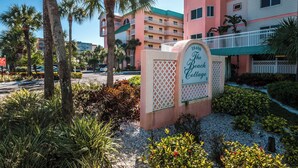 A multi-story building with a sign reading "The Beach Cottage." - PICTURE PERFECT!  3 balconies! BC #2406 (Indian Shores)