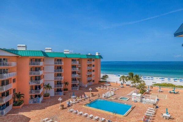 A hotel with multiple balconies, a swimming pool, and a beach view. - PICTURE PERFECT!  3 balconies! BC #2406 (Indian Shores)