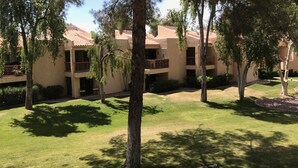 A courtyard with multiple-story buildings, trees, and a well-maintained lawn. - Stunning,  2 Bedroom Condo In Central Scottsdale at McCormick Ranch. (Scottsdale)