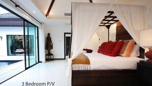 Propiedad de 3 habitaciones con un amplio ventanal que da a una piscina, una cama con dosel y una estatua al fondo.