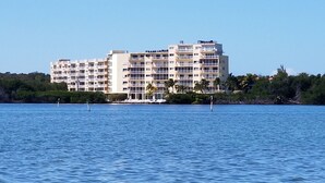 A multi-story hotel with balconies, located near a body of water. - SPECTACULAR OCEANFRONT VIEWS , FREE WIFI, HD SMART TV'S, SUMMER SPECIAL RATES (Tavernier)