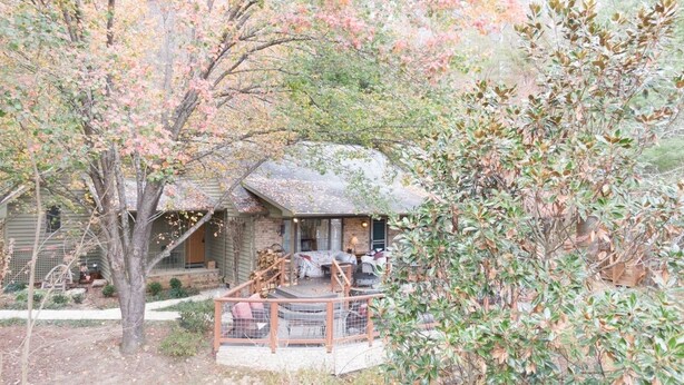 A rustic cabin with a porch, surrounded by trees and a wooden deck. - We weathered Helene beautifully!      Welcome to your new, lovely mountain home! (Asheville)