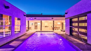 A modern house with a swimming pool, large windows, and a garage. - Sleeps 23: Luxury Retreat with Pool/Hot Tub, Casitas, Pet-Friendly, Near Riviera Marina (Lake Havasu City)