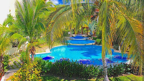 A swimming pool surrounded by palm trees and a gazebo. - PRIVATE ROOFTOP, HILLTOP PANORAMIC OCEAN-VIEW CONDO. COCO SUNSET HILLS, CR. (playas del coco)