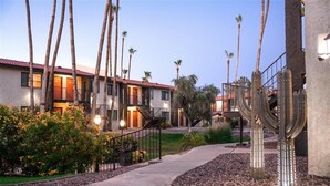 A residential area with a row of two-story houses, a paved walkway, and cacti. - 135  Perfect Scottsdale Location! (Scottsdale)