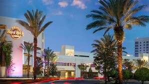 A Hard Rock Casino building with palm trees in front.