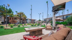 A courtyard with outdoor seating, a fire pit, and a pool.
