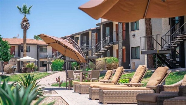 A hotel courtyard with outdoor seating, palm trees, and a staircase leading to the building. - 137 -Amazing Views-The Perfect Scottsdale Stay (Scottsdale)
