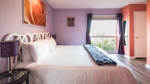 A bedroom with a large bed, a bedside table with a lamp, a window with curtains, and a view of greenery outside. - View, 1 King bed & sleeper; .33 mi to Barton Springs/Zilker Park, @2 mi to DT! (Austin)