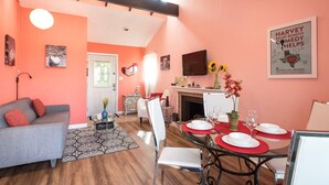 A living room with a sofa, a dining table set for four, and a fireplace. - View, 1 King bed & sleeper; .33 mi to Barton Springs/Zilker Park, @2 mi to DT! (Austin)