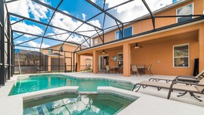 A pool area with a glass ceiling, lounge chairs, and a dining area. - Serene Pool Home Overlooking Conservation Area 🌳🏊‍♂️ (Davenport)