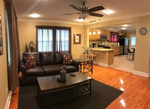 Relax in this open-plan living space with a comfortable sofa and dining area.