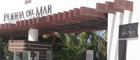 A gated entrance with a sign reading "Puerta del Mar" and "Access Condominiums Owners Access".