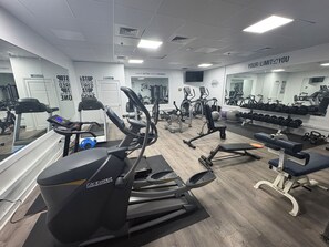 A gym with various exercise equipment, including treadmills and weight machines. - Oceanfront and Bay view at the Carousel with indoor pool (ocean city)