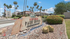 Scottsdale Park Suites sign, palm trees, and a cactus garden. - 219 Fully Furnished, WiFi Included! (Scottsdale)