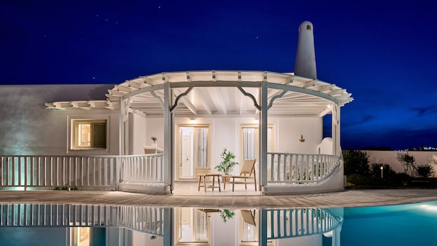 A poolside area with a covered seating area, a staircase, and a view of the night sky. - La Maison Villa with Large Private Pool - Accommodates 10 (SANTORINI)