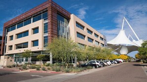 A modern building with a parking lot and a distinctive white structure in the background. - 121 Chic Scottsdale Retreat | Heated Pool, Outdoor Lounge & 2 Miles from Old Town! (Scottsdale)