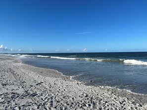 A beach with a clear sky and waves.