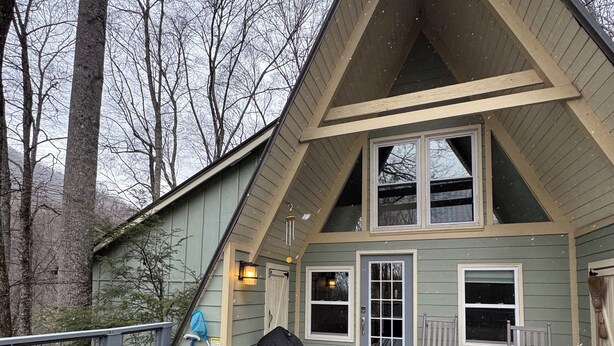 A wooden deck with outdoor seating and a hot tub. - A-Frame of Mind in the Smoky's, a mountain retreat. (Whittier)