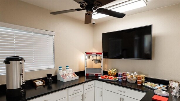 A kitchen with a coffee maker, microwave, and food items on the counter. - 120 Living in Ultimate Comfort | Pool, Lounge & Full Kitchen Suite! (Scottsdale)
