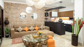 A modern living room with a sofa, coffee table, and decorative mirrors.