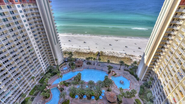 A high-rise hotel with a pool area, beach view, and multiple balconies. - Endless Views From Double Balcony! (Panama City Beach)