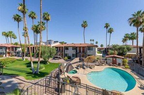 A hotel with a swimming pool, palm trees, and a clear blue sky. - 139 Gated Community with Resort-Style Amenities (Scottsdale)