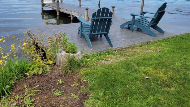 A dock with two Adirondack chairs and a flower arrangement. - 5 minutes to Peek n Peak, ON SITE PRIVATE HOT TUB, Large private yard (Clymer)