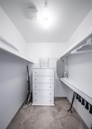 A small, white utility room with a white chest of drawers, a basket on top, and a hanging rack with items. - 228 Stay & Play,Onsite Putting Green-Prime Location! (Scottsdale)