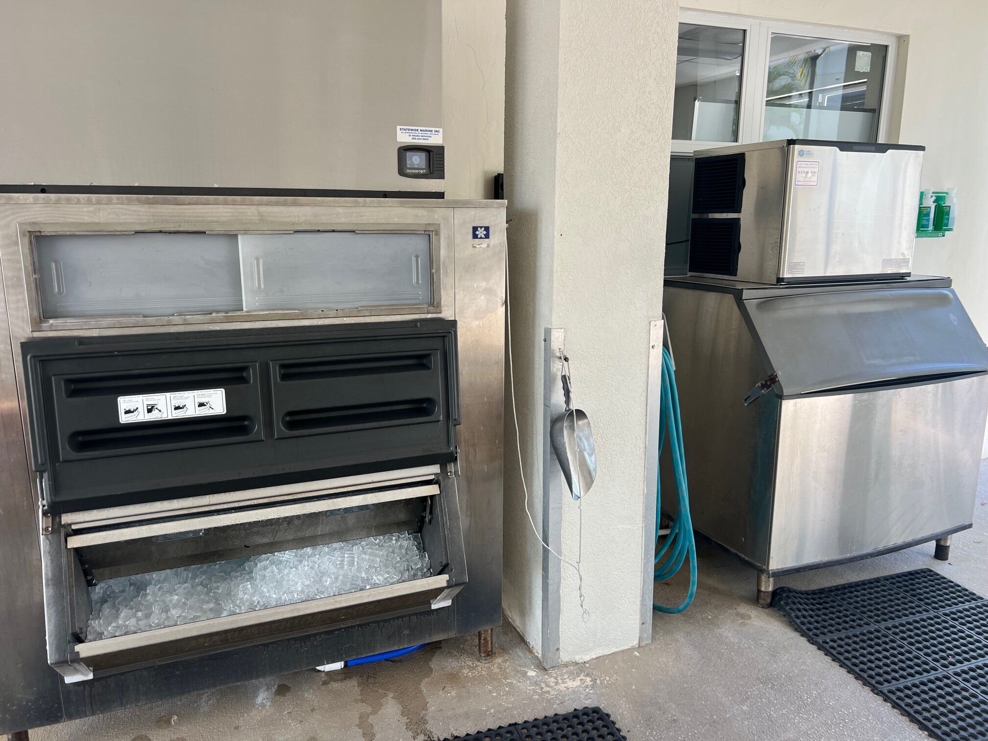 A commercial kitchen with stainless steel appliances, a water dispenser, and a metal grate.