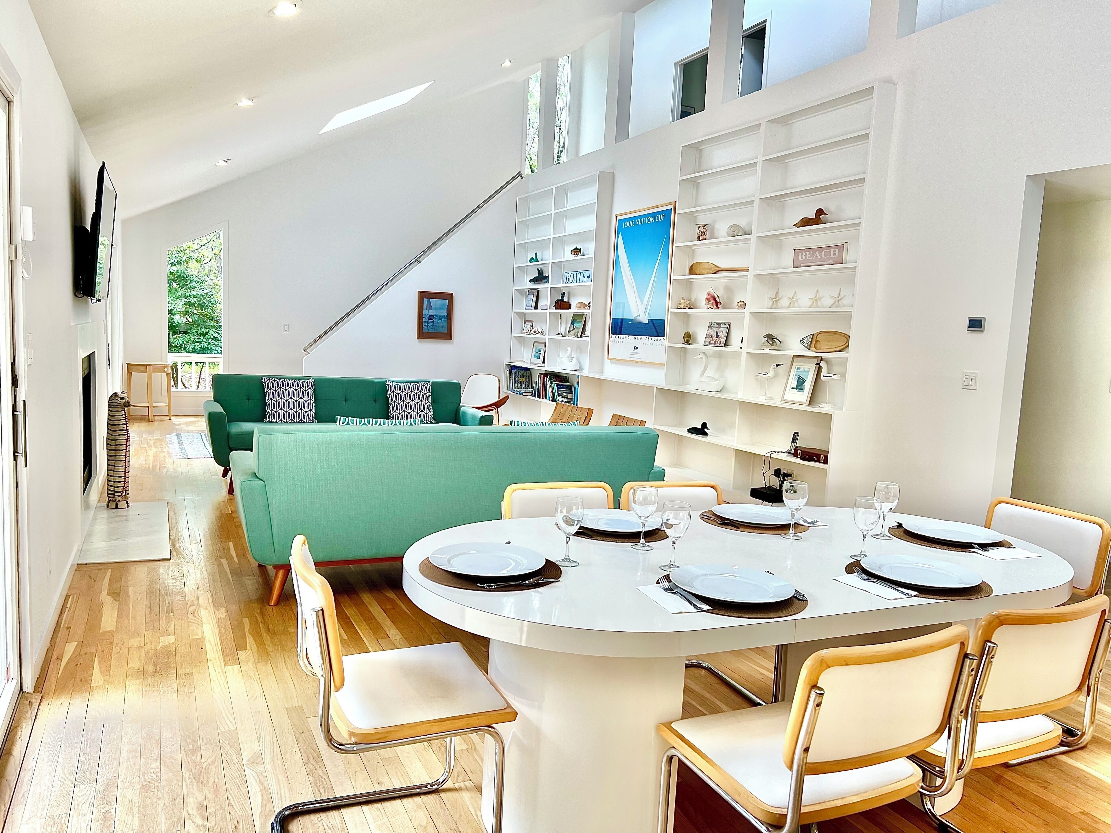 Living/dining area w/ vaulted ceilings, skylights, & 2 sliders leading to pool