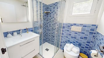 Een haardroger, handdoeken, zeep, toiletpapier
