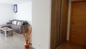 A modern living room with a sofa, coffee table, and a decorative vase. - Superb villa in Porto-vecchio  (Porto-Vecchio)