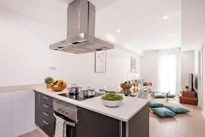 A modern kitchen with a central island, stainless steel appliances, and a large window. - BARCELONA DOWNTOWN! - Several 3Bdrs+2bths units! (Barcelona)