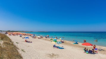 On the beach, sun-loungers
