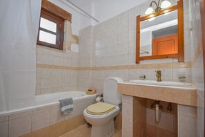 A bathroom with a bathtub, toilet, and sink. - Stone Villa Olga shared pool & seaview, 3bedrooms, BBQ (Astratigos)