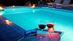 A swimming pool with lounge chairs and candles. - Ancient country villa with pool in the hills of Tuscany, surrounded by woods  (Poppi)