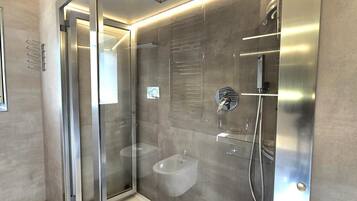 Regadera, secadora de cabello, bidet, toallas